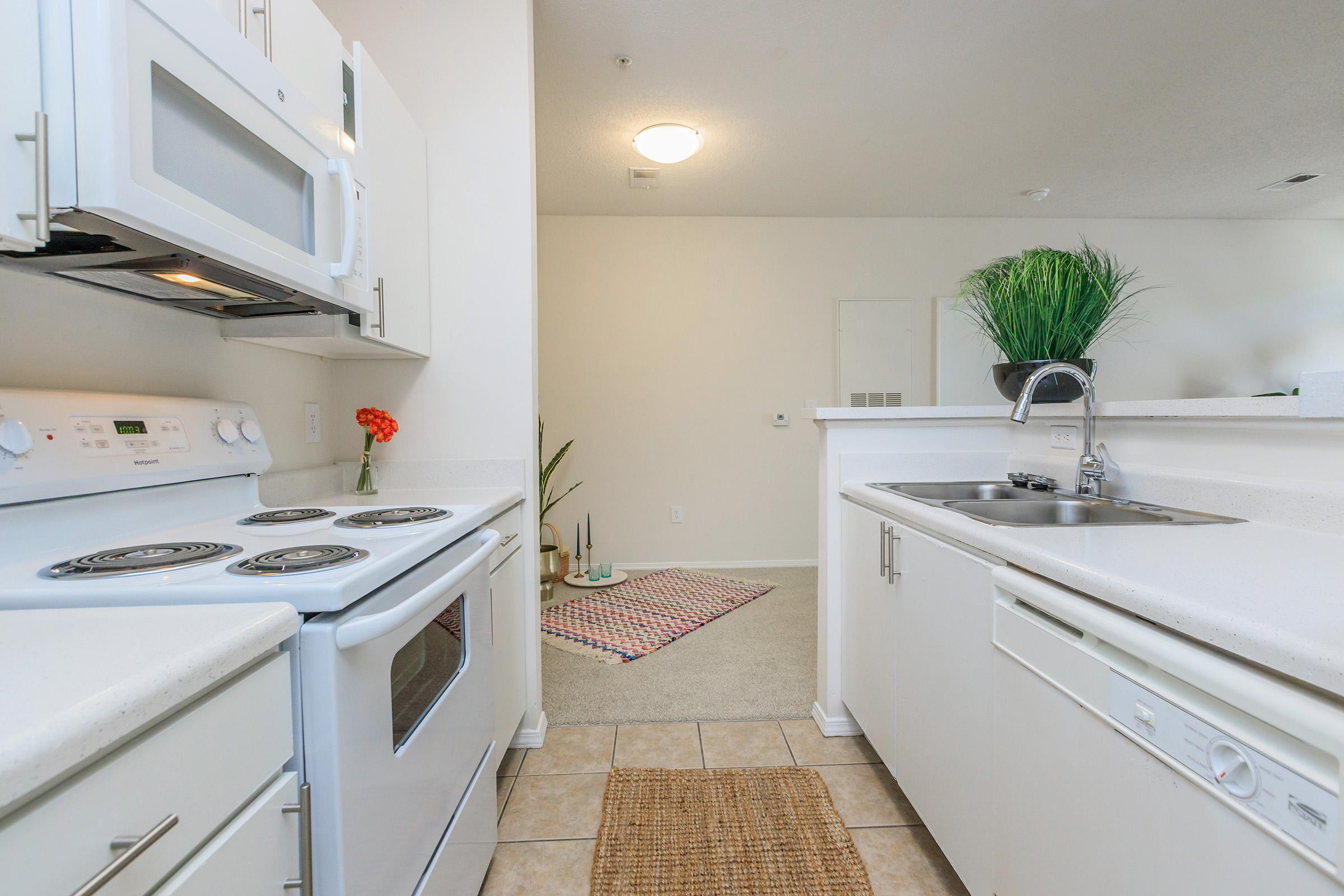 a stove top oven sitting inside of a kitchen