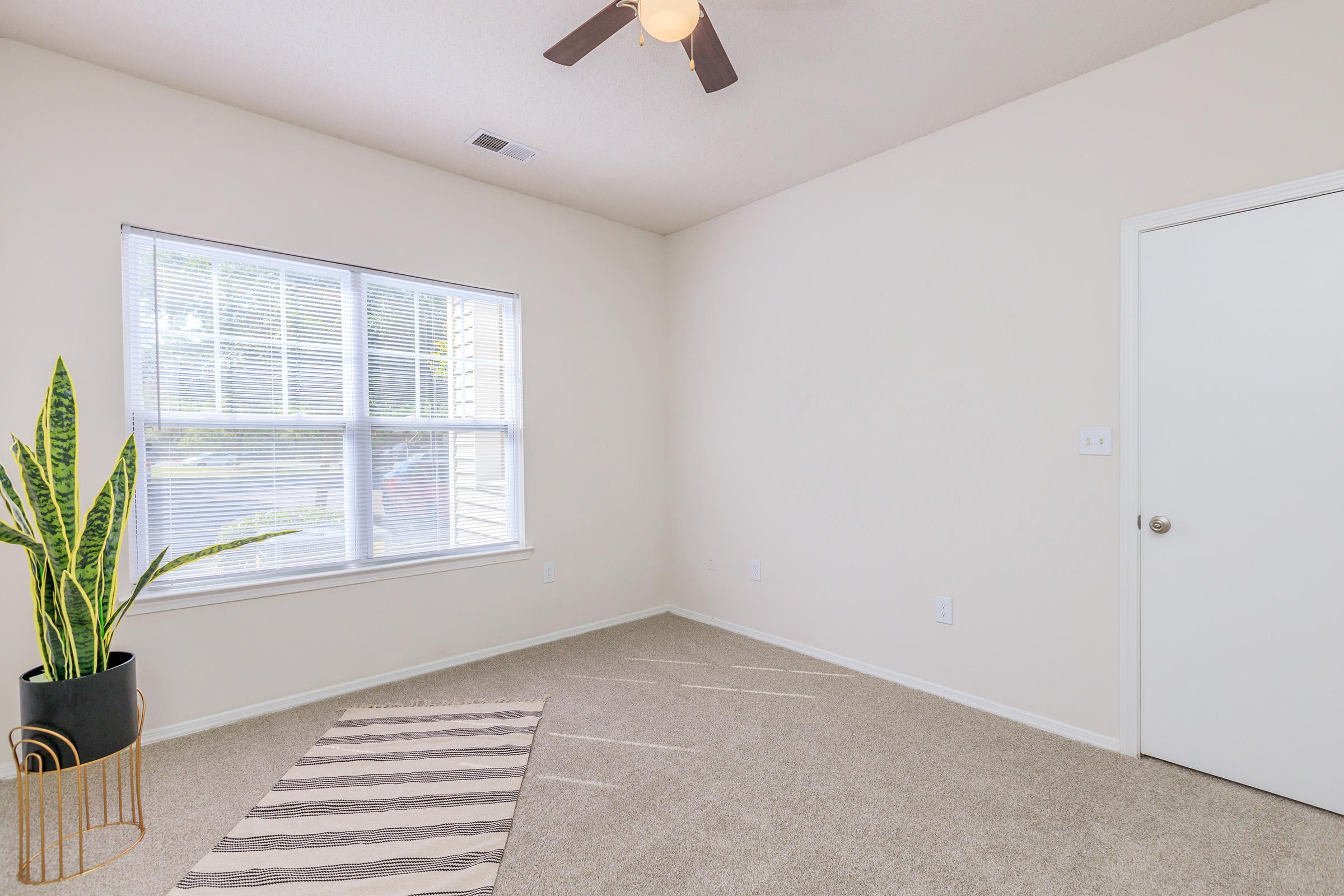 a bedroom with a large window