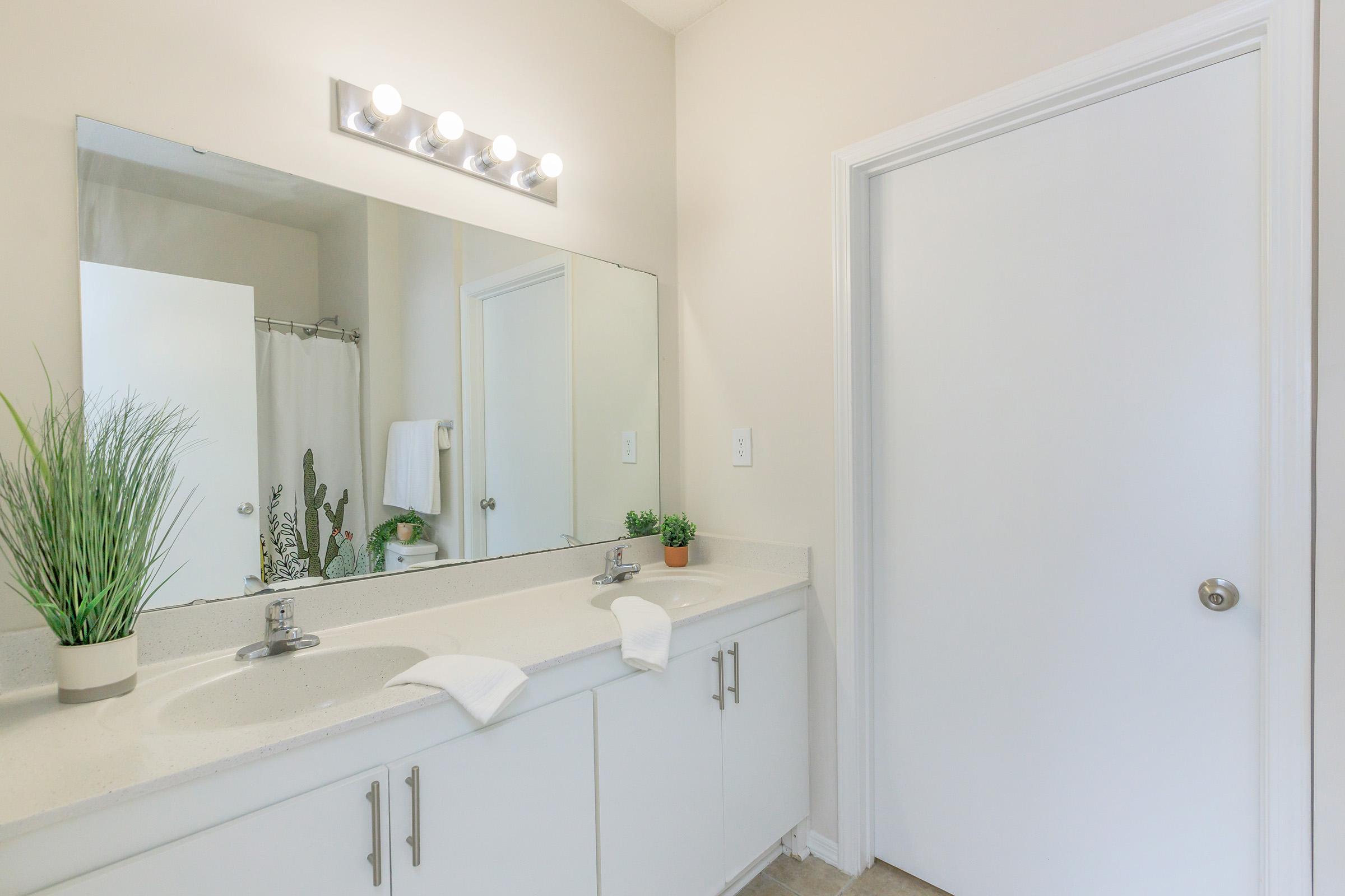 a kitchen with a sink and a mirror