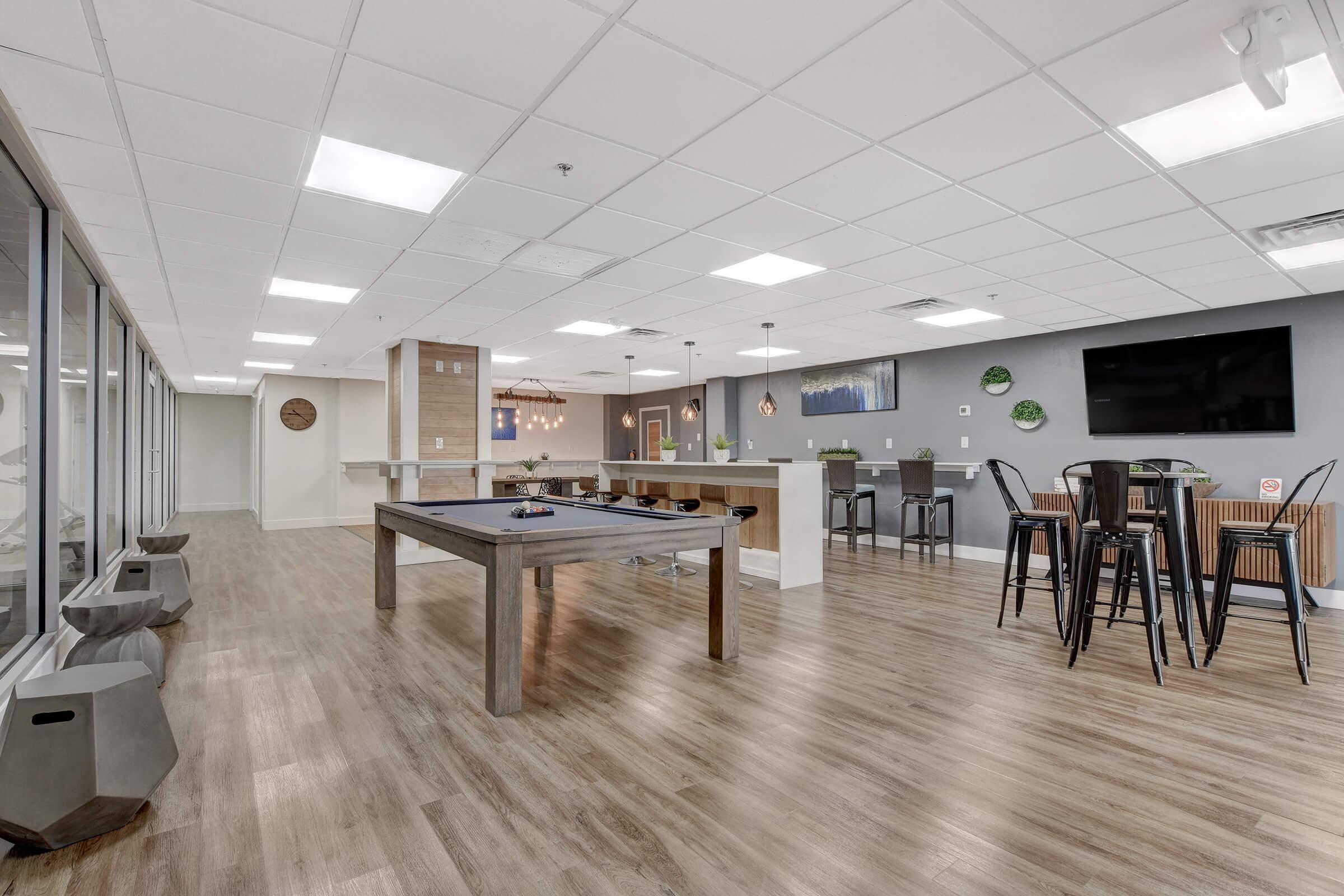 a room filled with furniture on top of a wooden floor