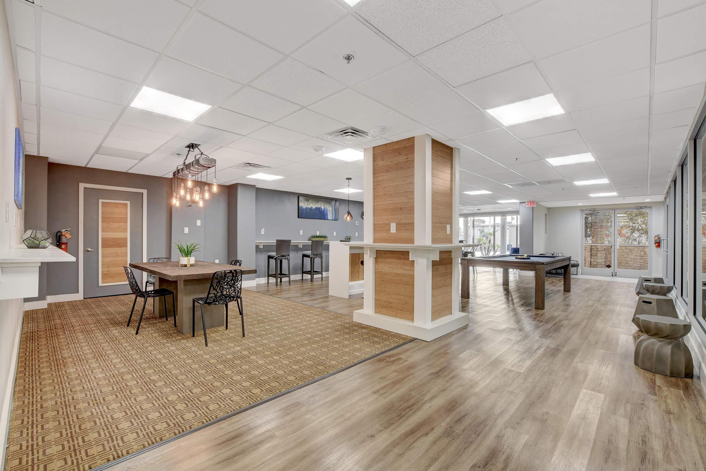 a room filled with furniture on top of a wooden floor