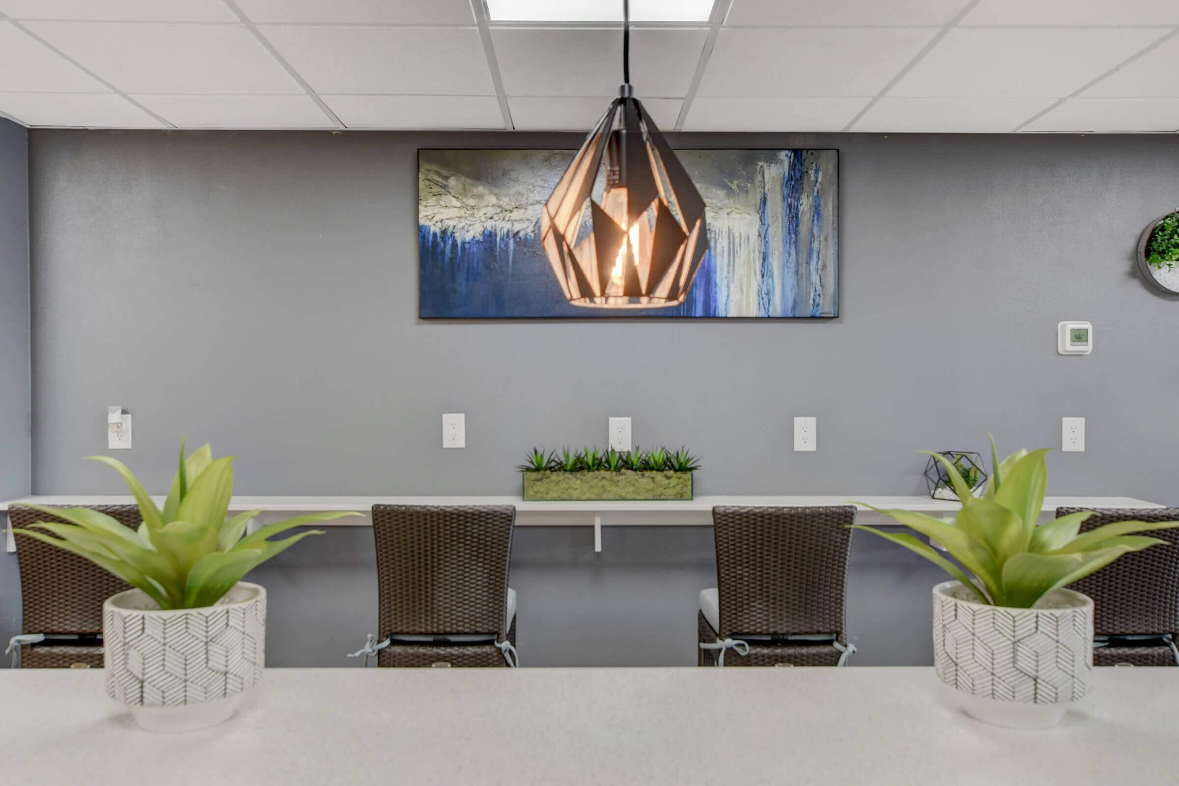 a room filled with furniture and vase of flowers on a table