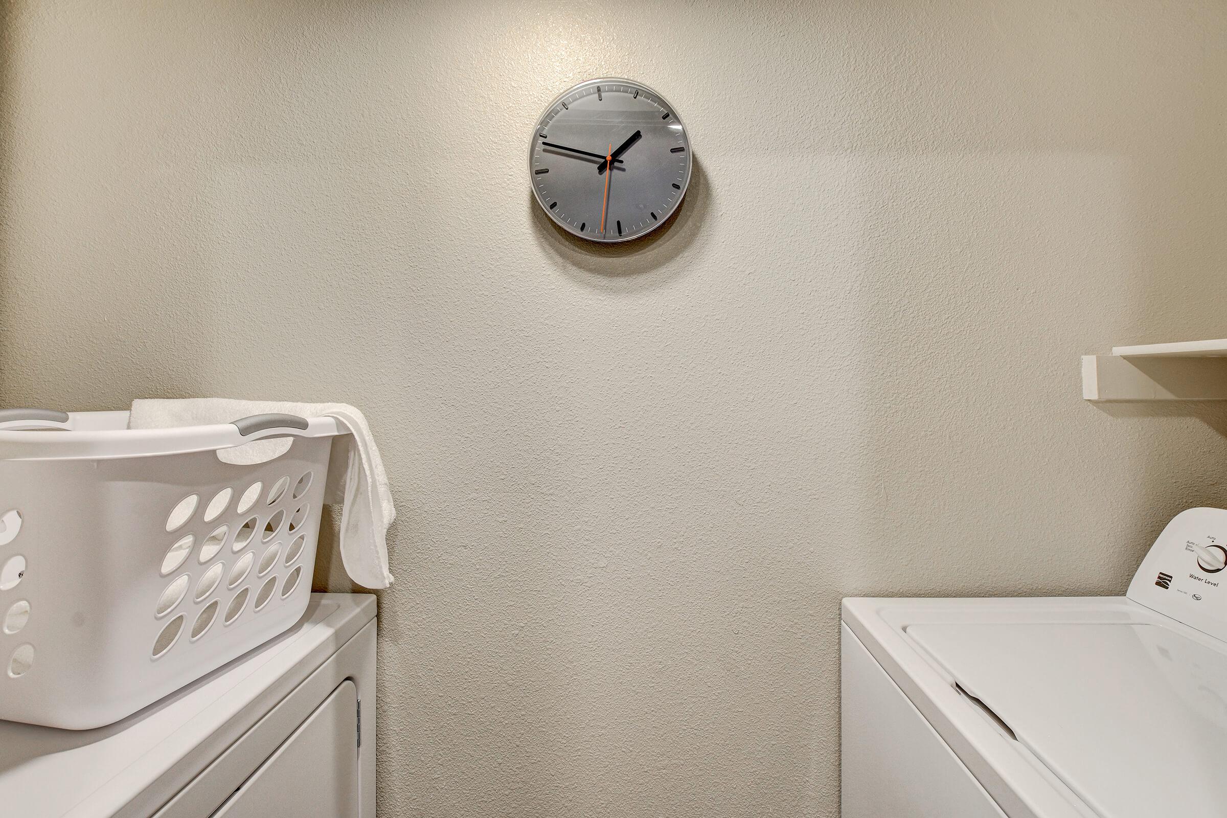 a clock sitting in front of a mirror posing for the camera