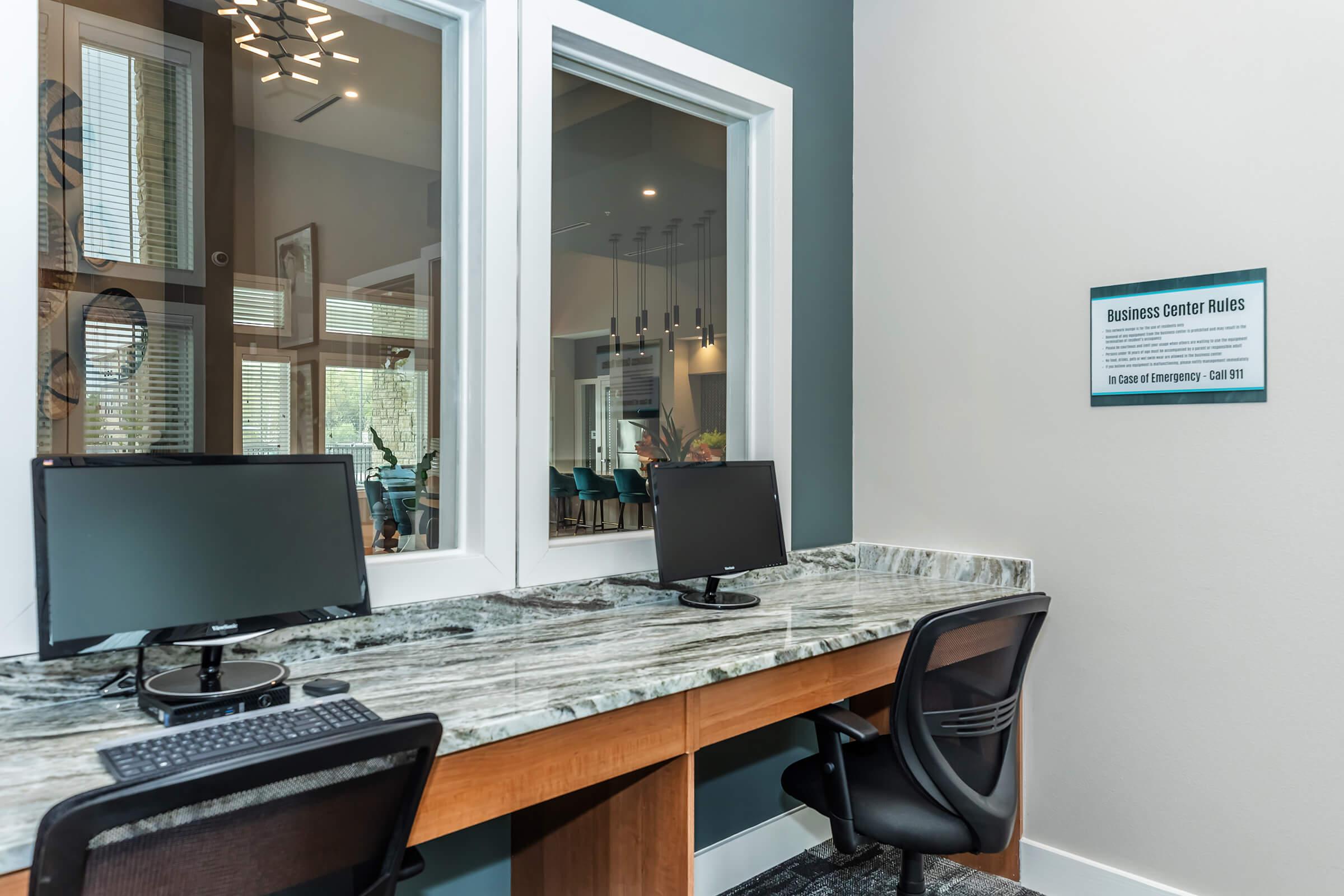 a desk with a laptop computer sitting on top of a table