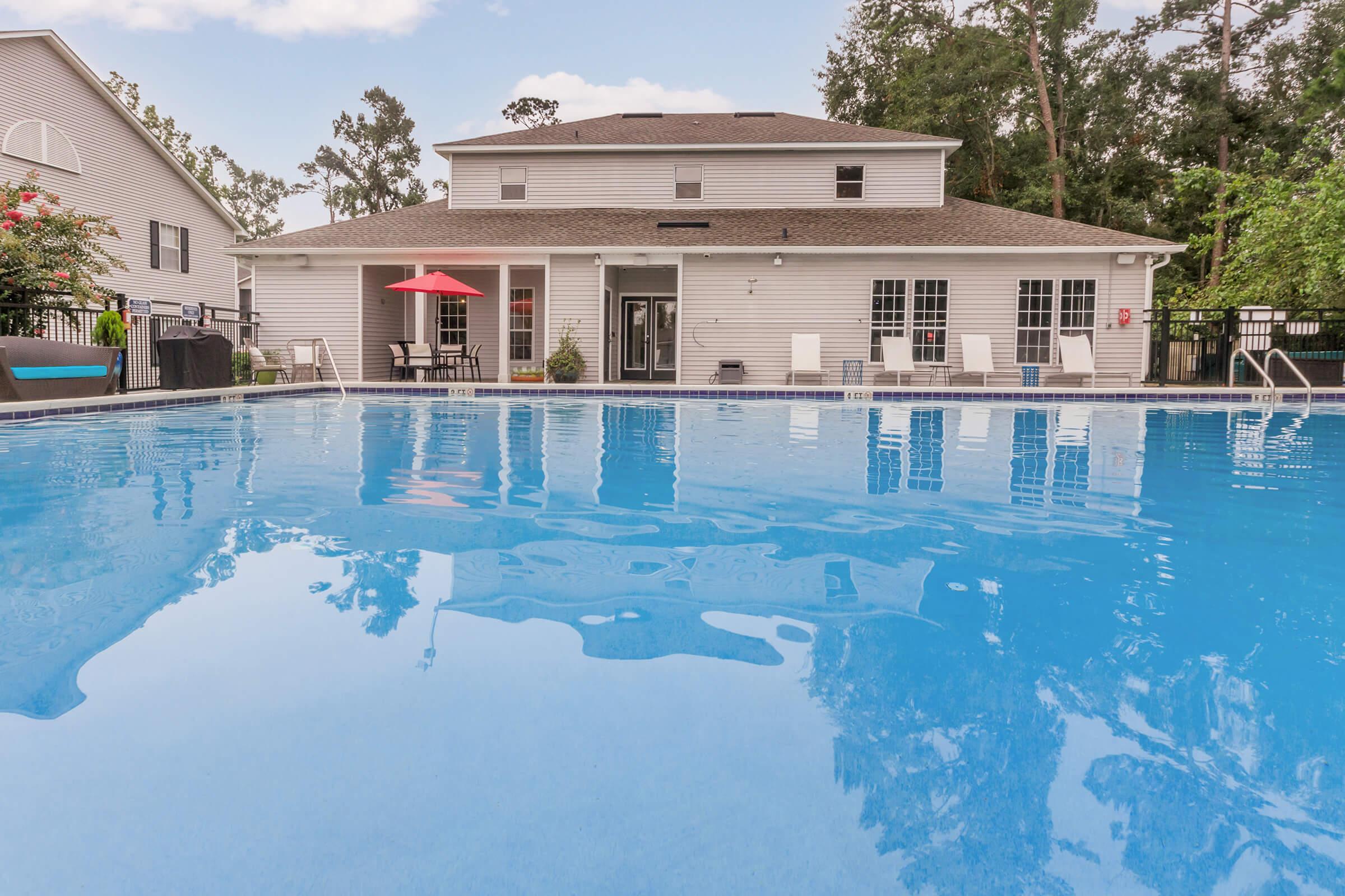 a large pool of water in front of a house