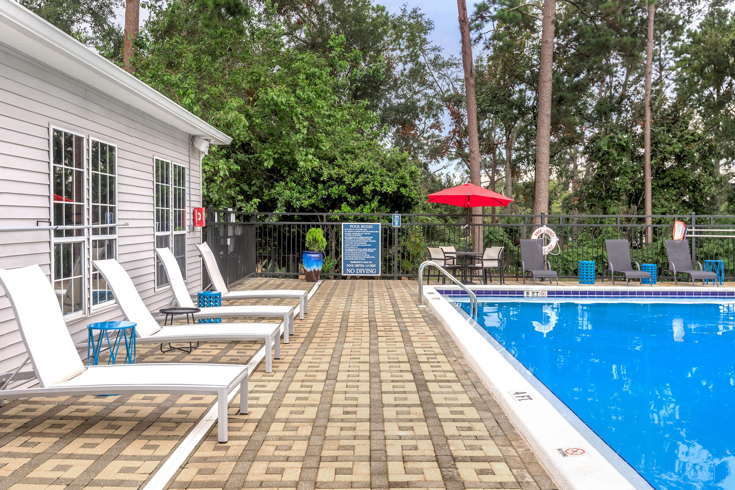 a bench in front of a pool