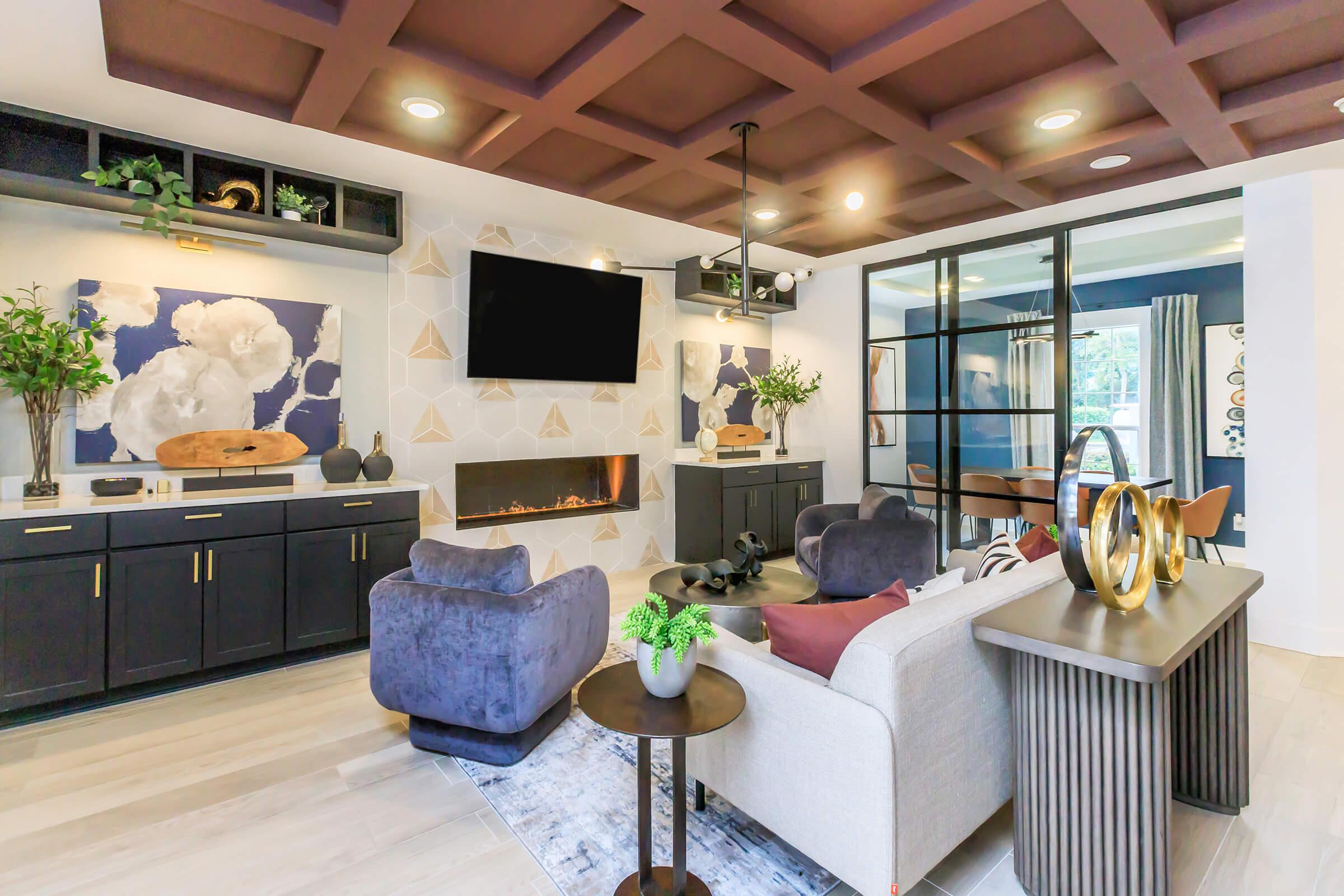 a living room filled with furniture and a large window