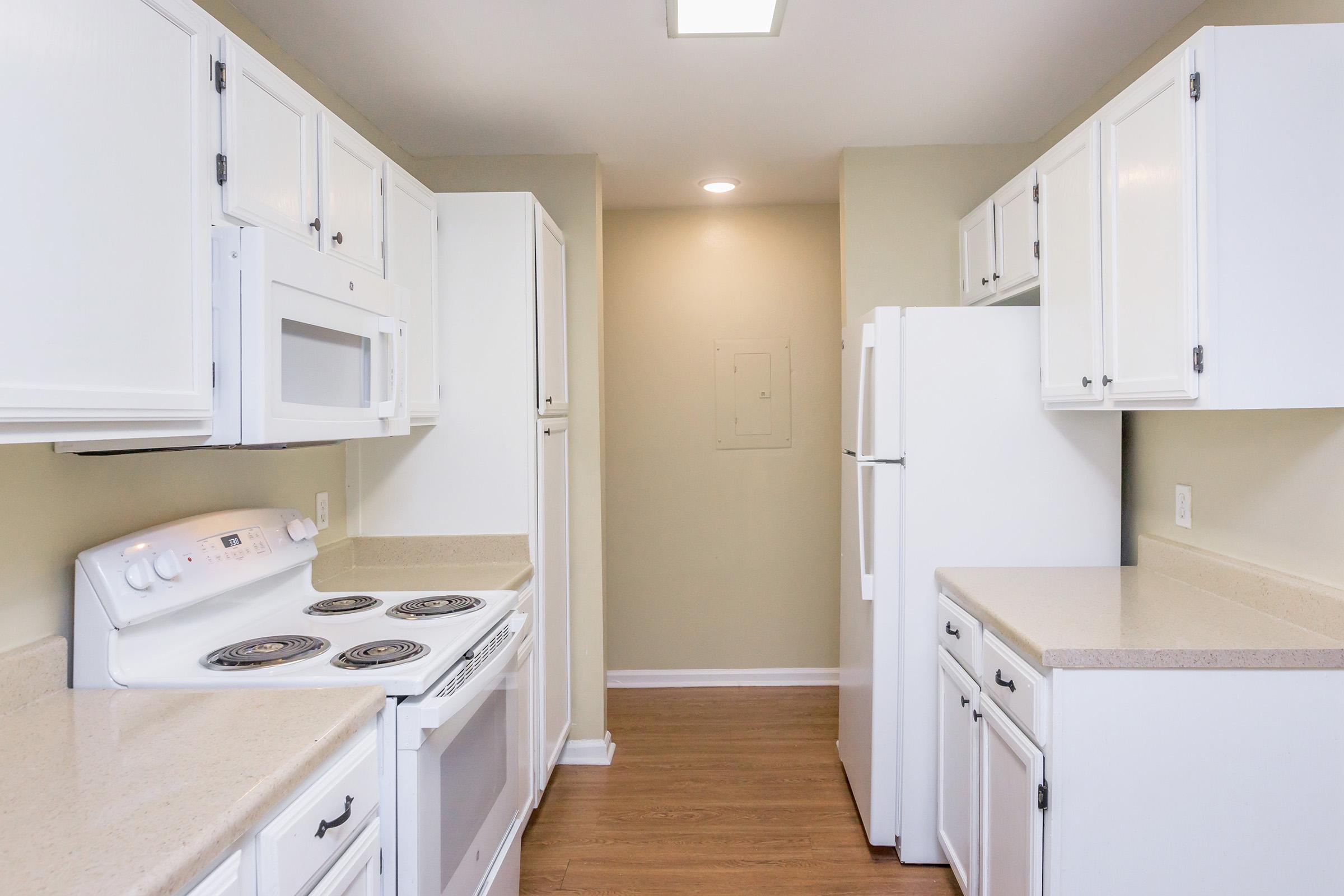 a kitchen with a stove sink and refrigerator