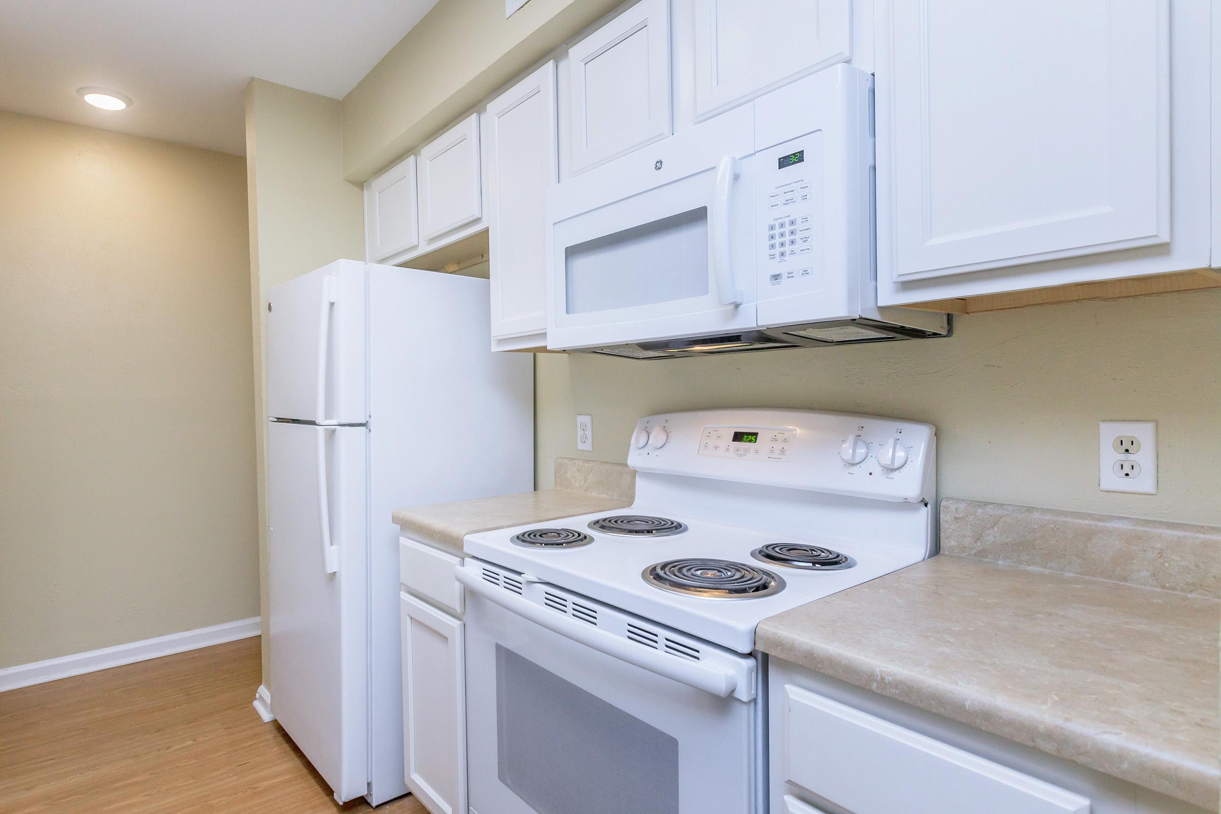 a stove top oven sitting inside of a kitchen