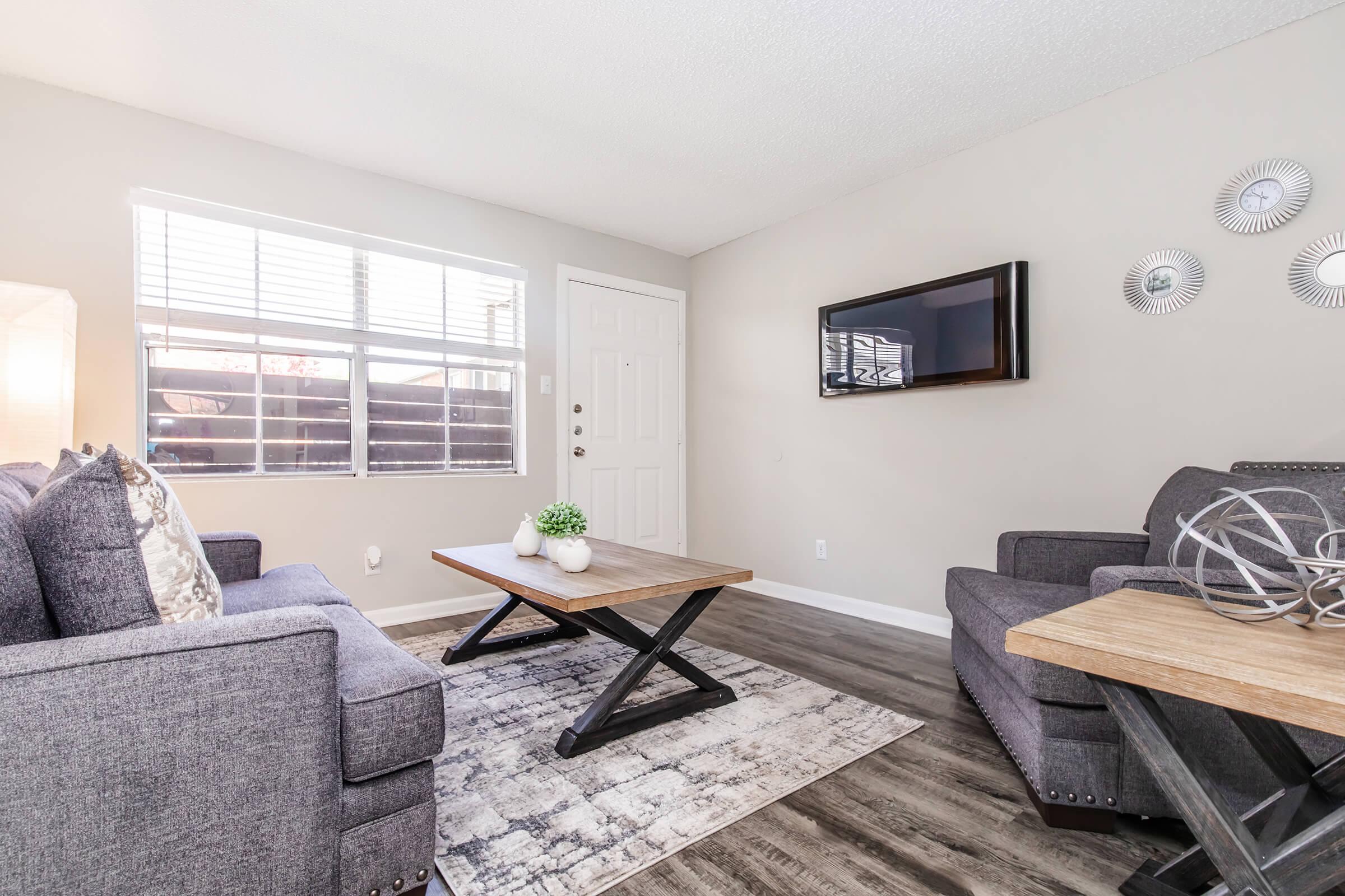 a living room filled with furniture and a large window