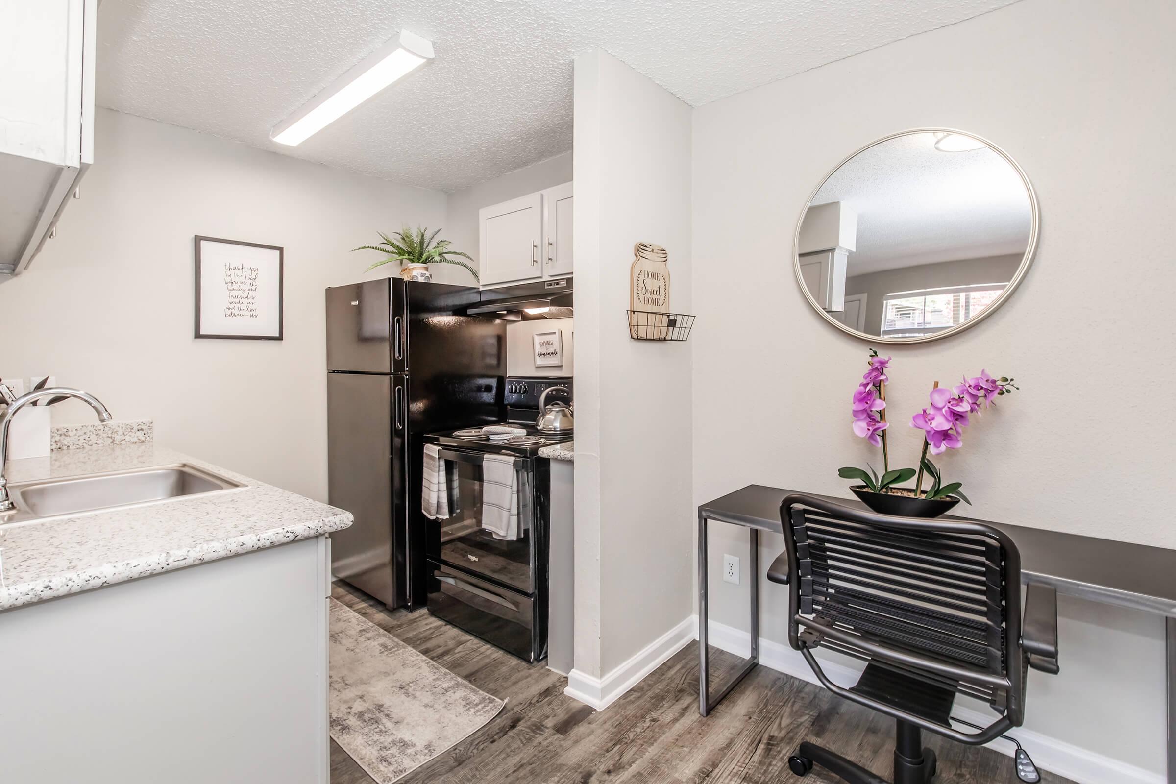 a kitchen with a sink and a mirror