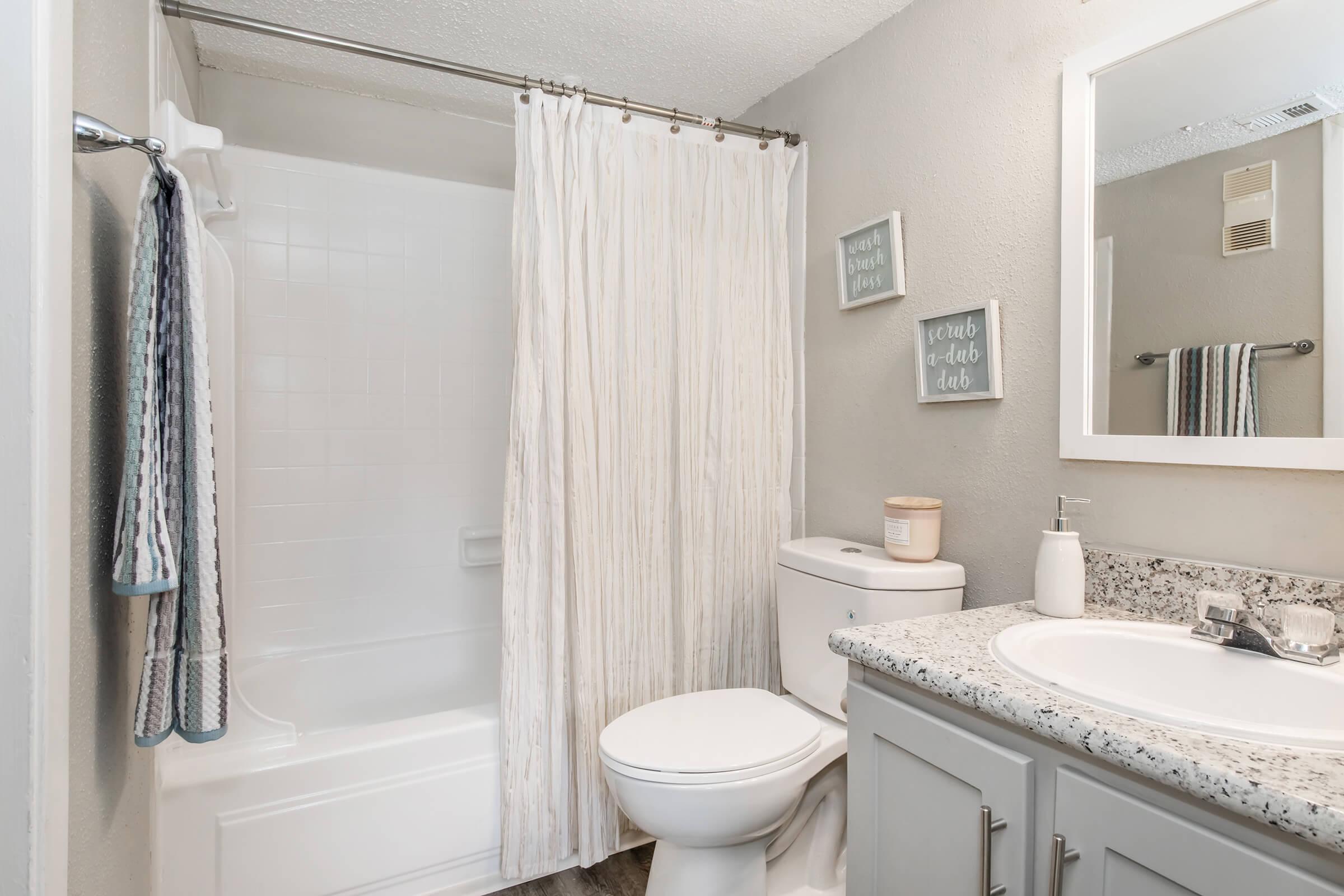 a shower that has a sink and a mirror