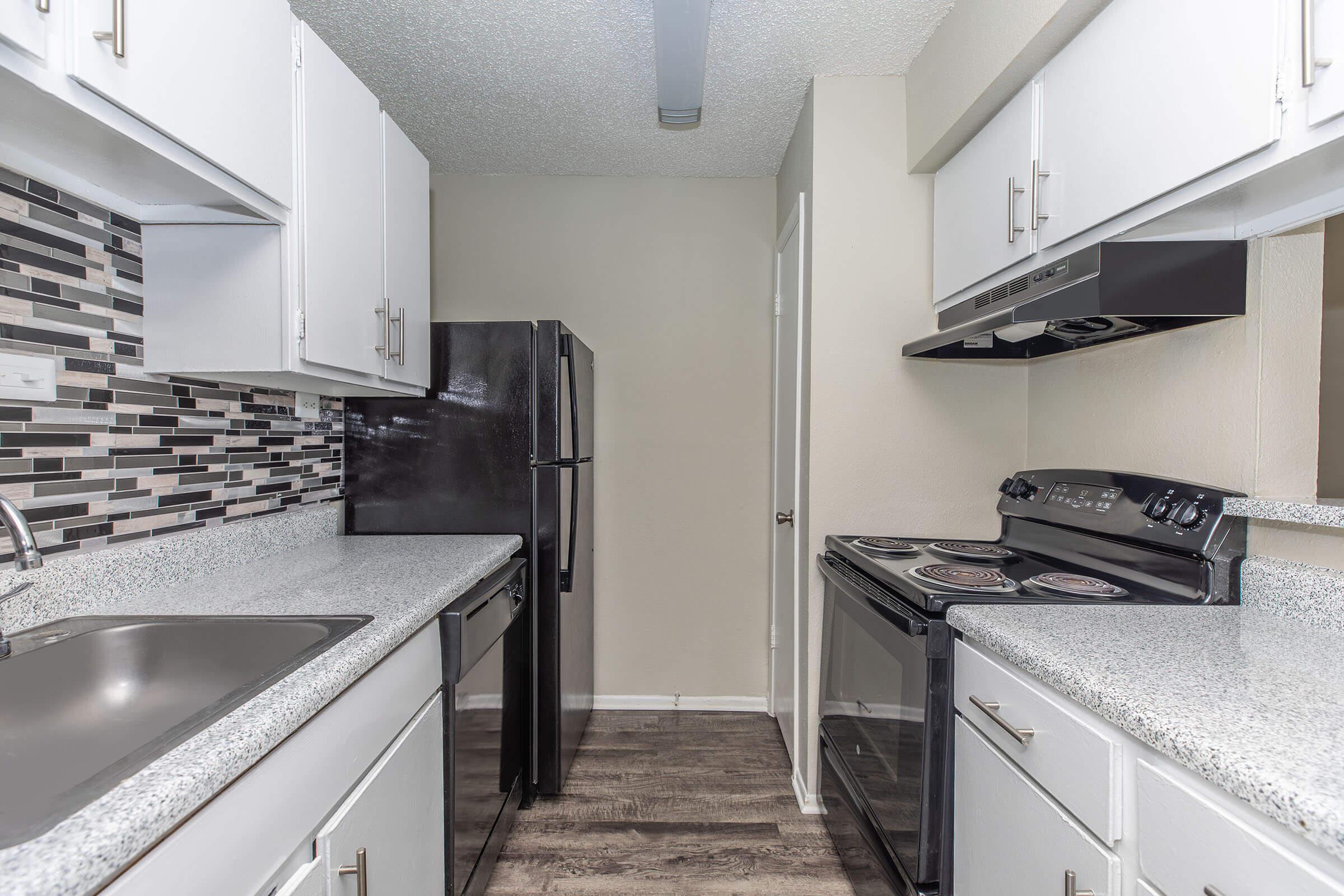 a kitchen with a stove and a sink