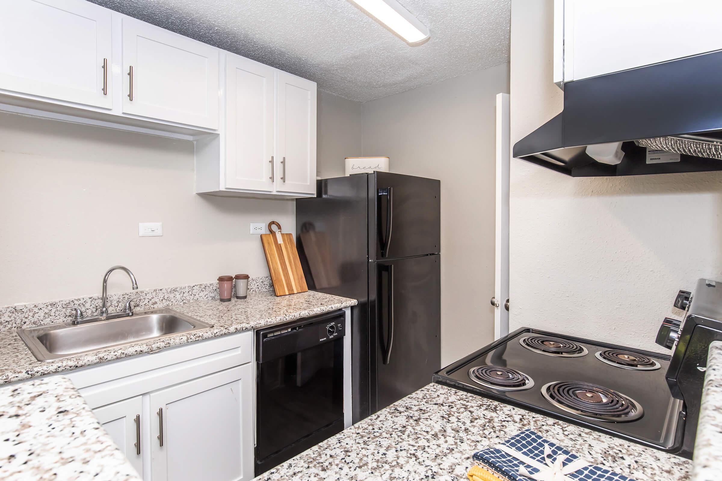 a kitchen with a sink and a mirror