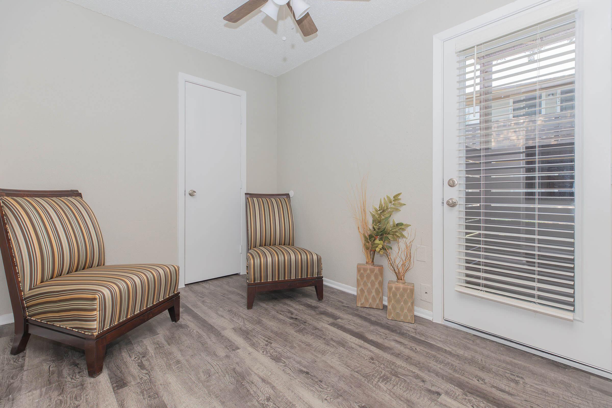 a living room filled with furniture and a window