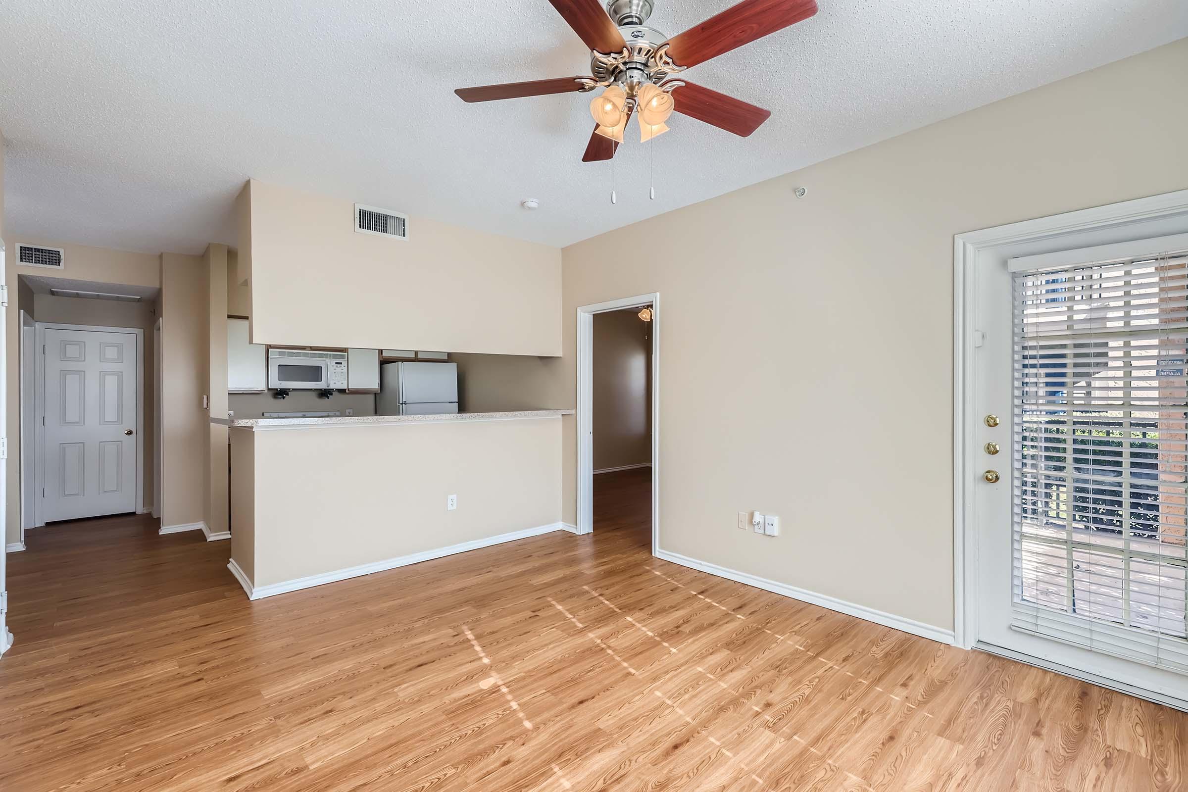 Wood-style flooring, a kitchen and French doors leading to a patio at Rise Skyline.
