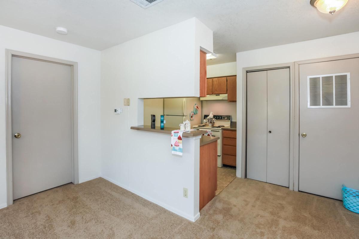 a kitchen with a sink and a mirror in a room