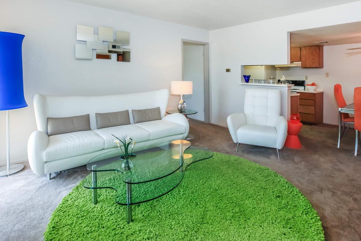 a living room filled with furniture and a rug