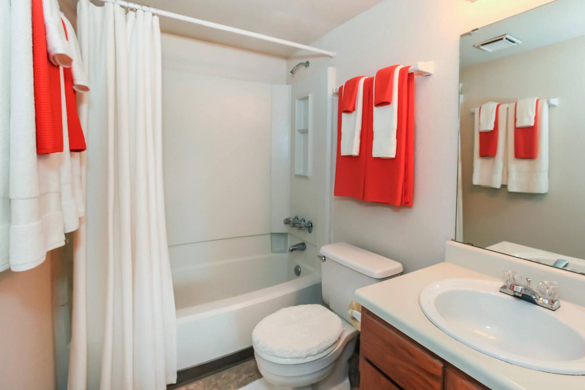 a white sink sitting next to a shower