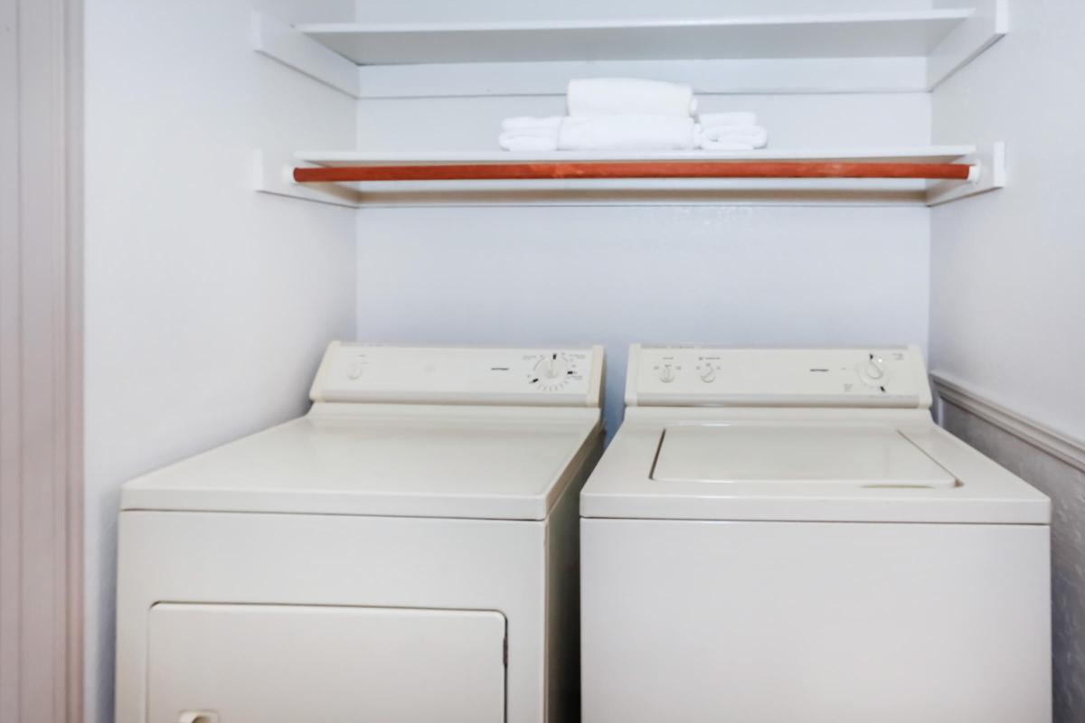 a white microwave oven sitting on top of a refrigerator