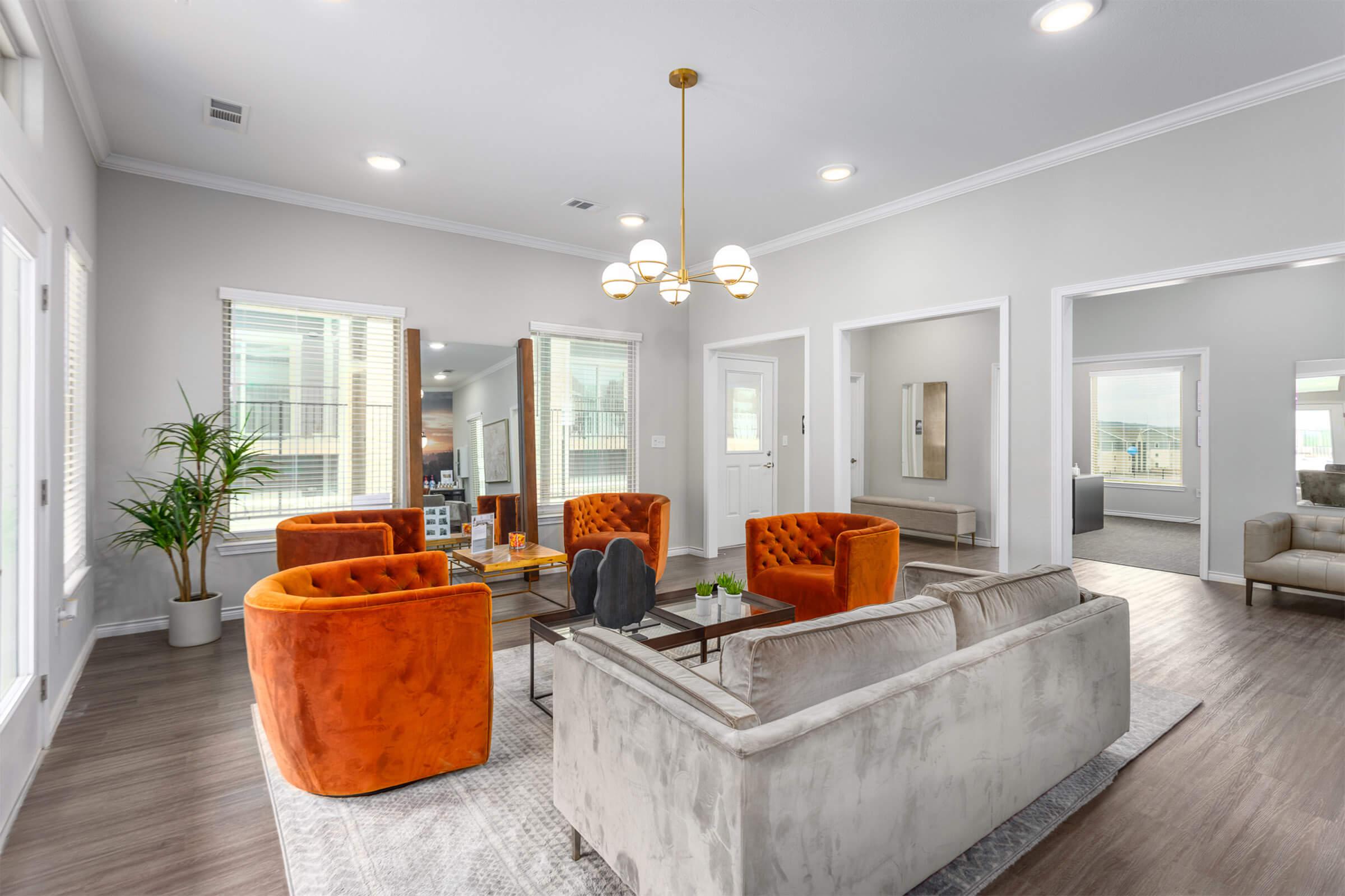 a living room filled with furniture and a large window