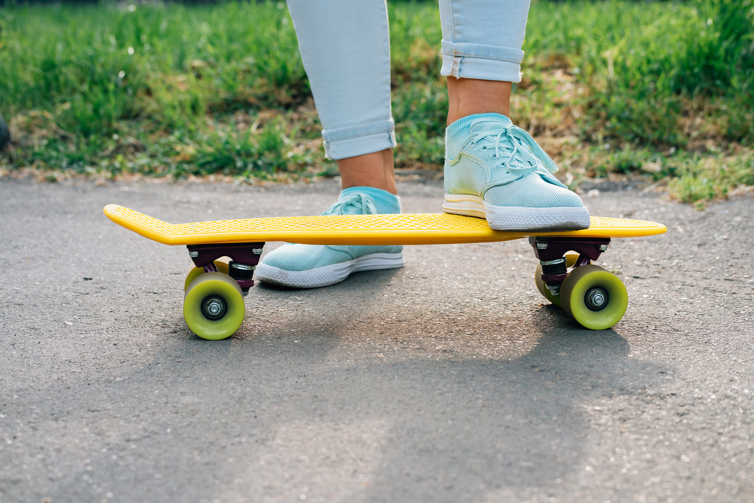 a person wearing a helmet riding a skateboard up the side of a road