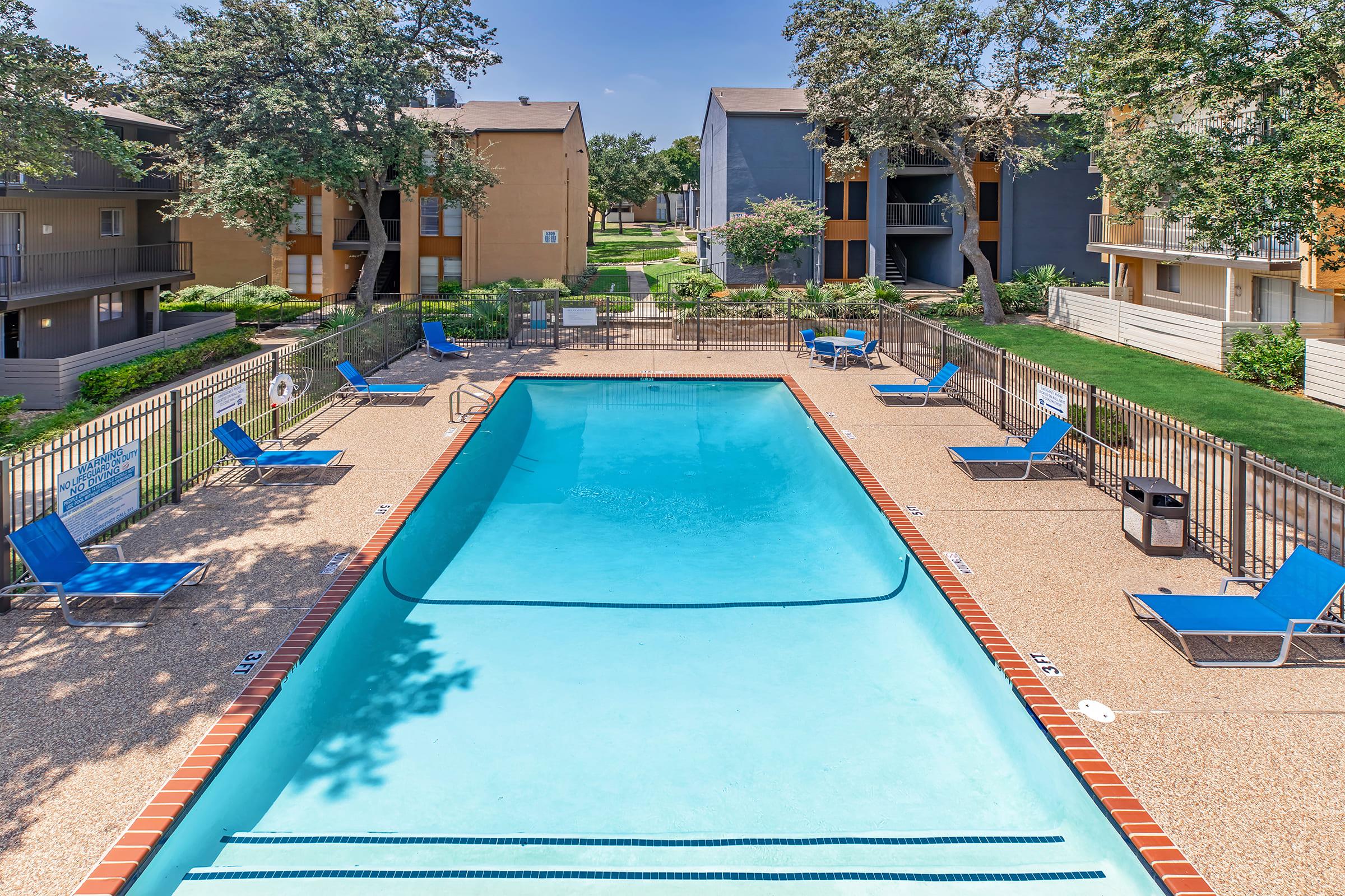 a group of lawn chairs sitting next to a pool