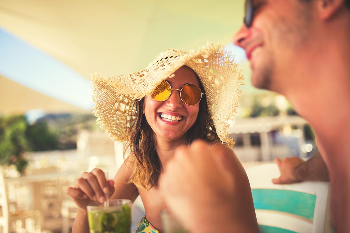 a person wearing a hat and sunglasses