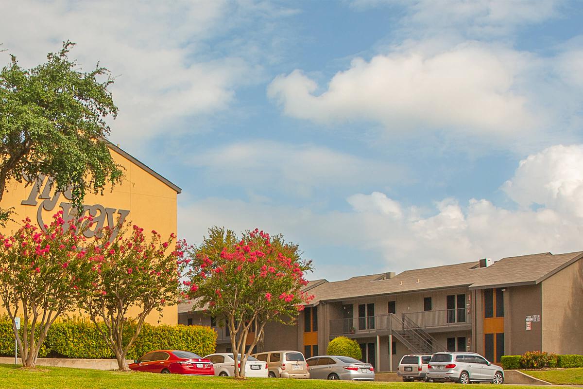 The Way Apartments community buildings with green trees