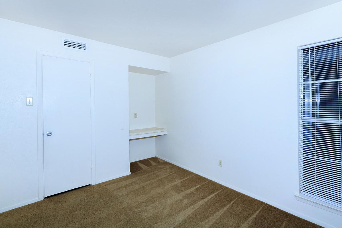 carpeted bedroom with a built-in desk