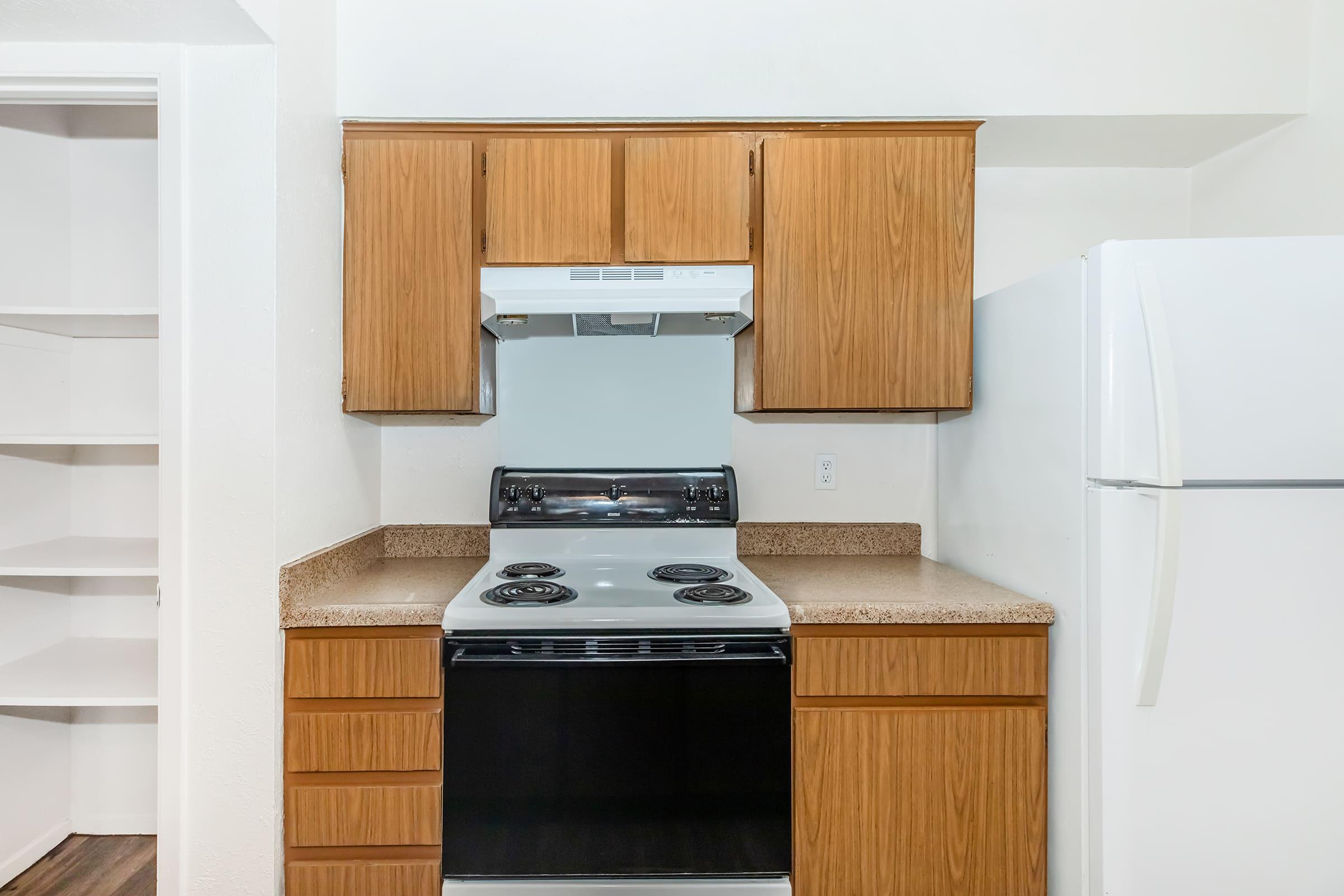 a kitchen with a stove top oven sitting inside of a refrigerator