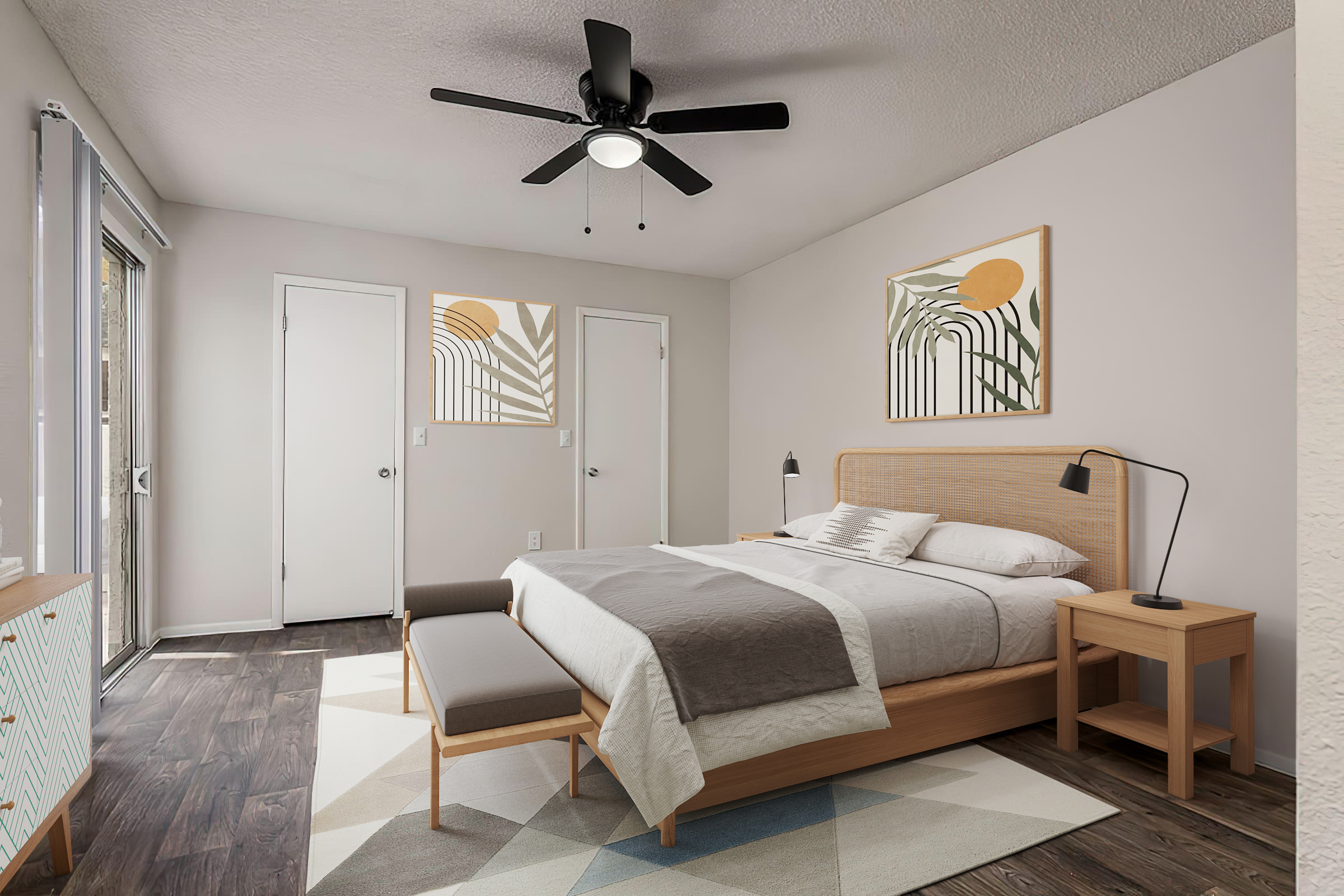 A modern bedroom featuring a queen-sized bed with neutral bedding, a stylish wall-mounted fan, and two decorative wall art pieces. A bench at the foot of the bed, a bedside lamp on a wooden nightstand, and a light-colored dresser complete the room. Large windows allow natural light to fill the space.
