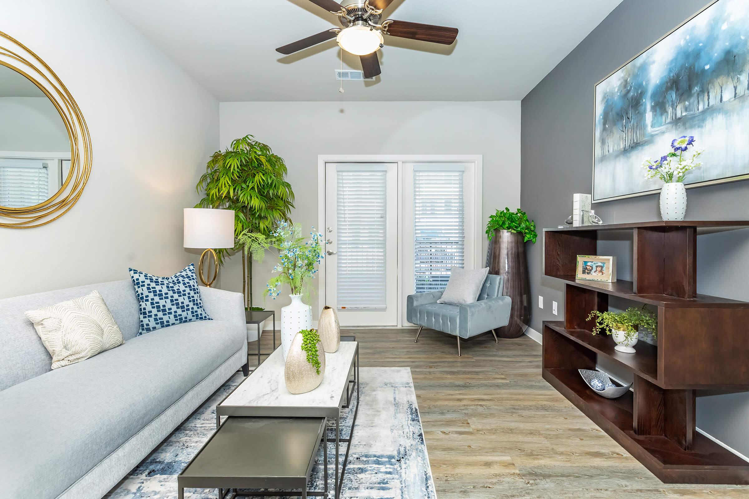 a living room filled with furniture and a large window