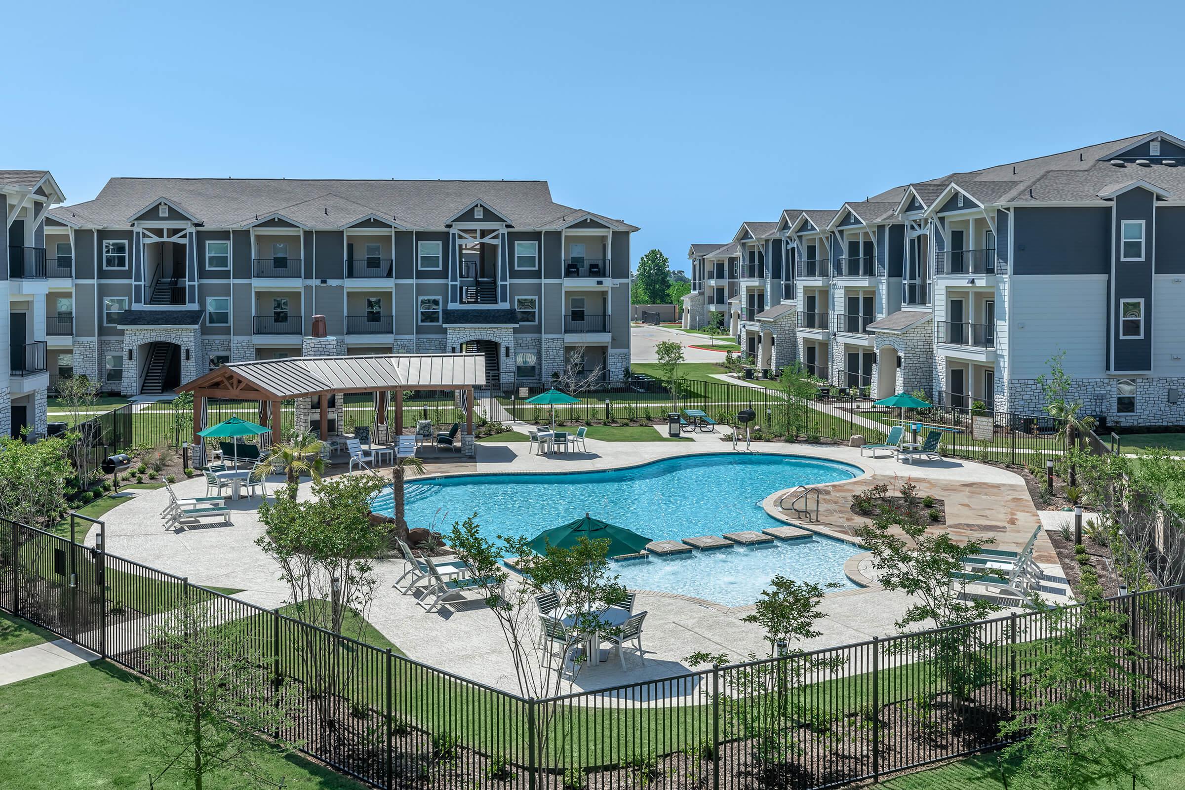 a house with a pool in front of a building