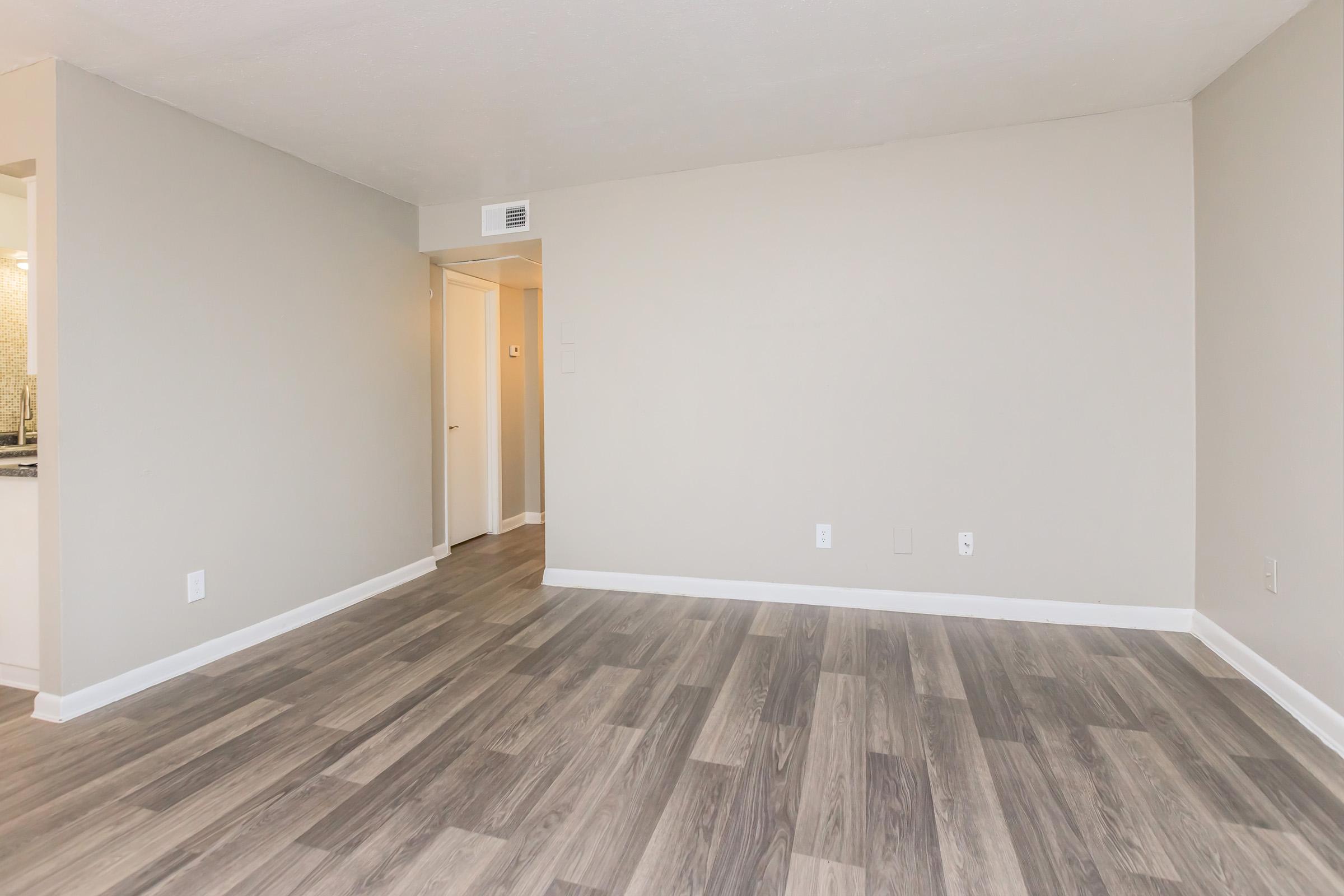 a large empty room with a wood floor