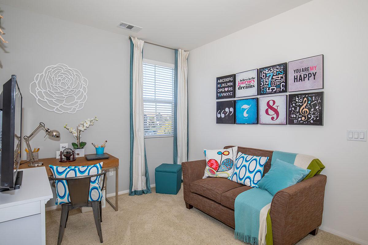 a living room filled with furniture and a large window