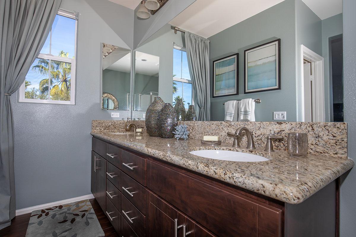 a kitchen with a sink and a mirror