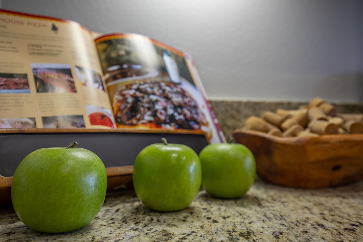 a green apple in front of a fruit