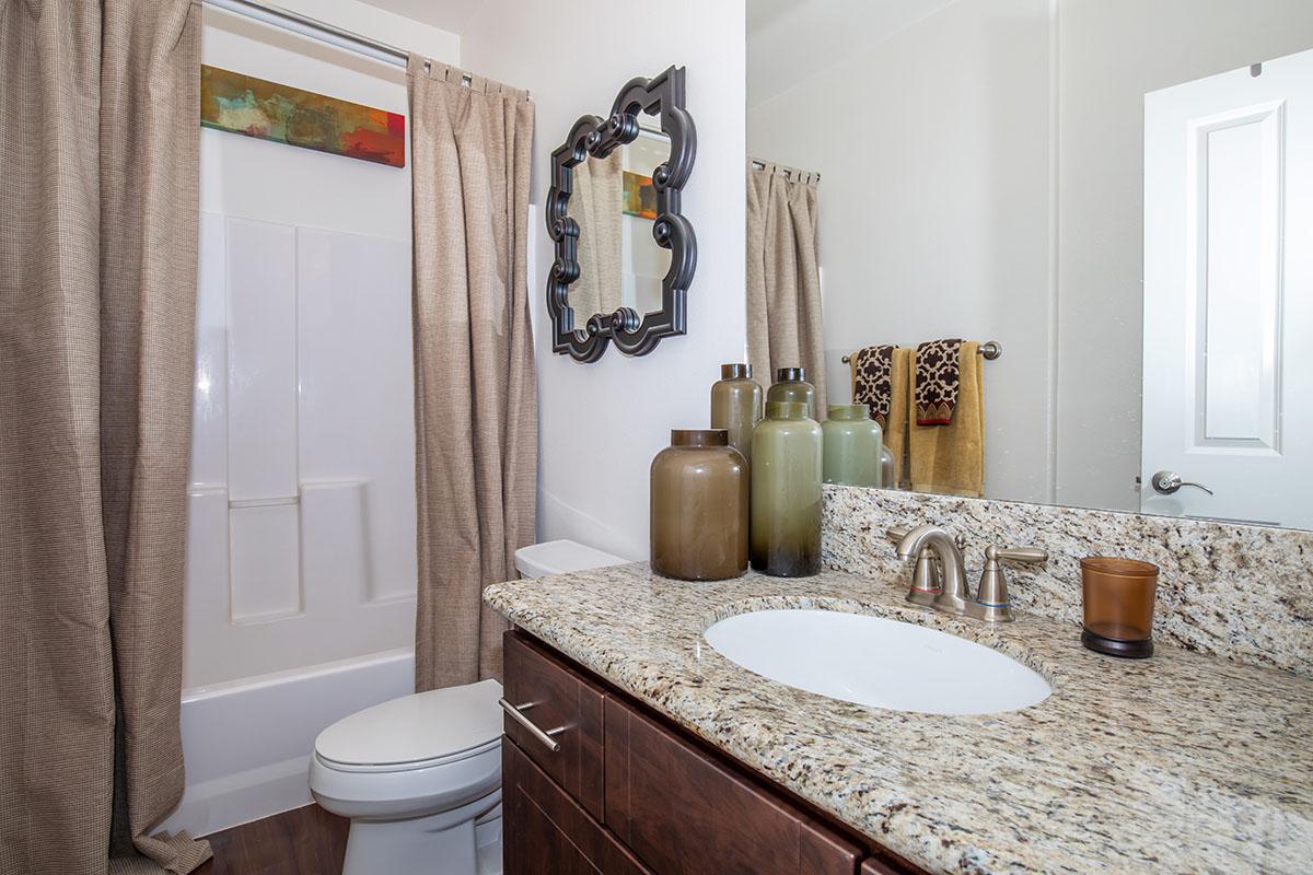 a hotel room with a sink and a mirror