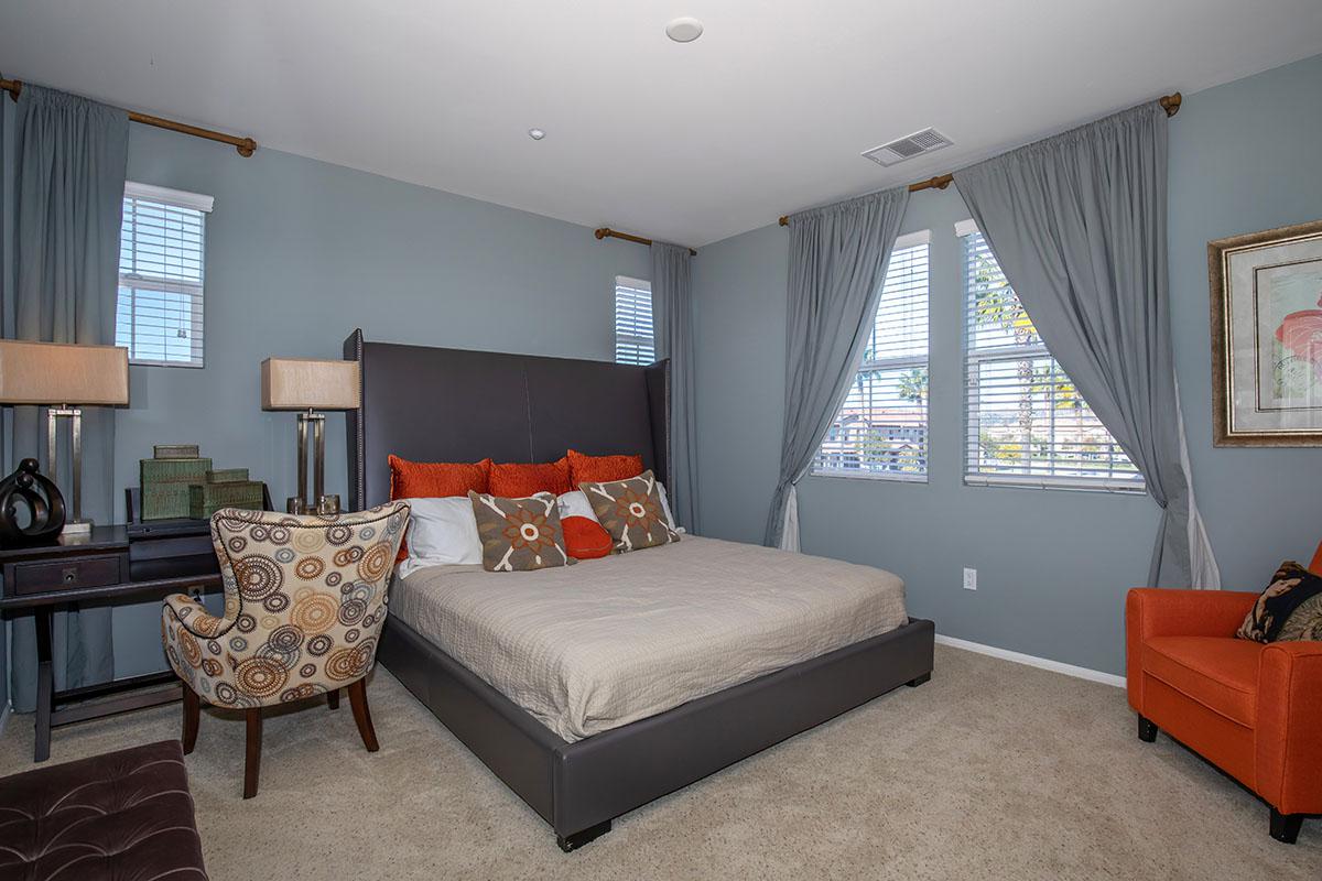 a living room filled with furniture and a flat screen tv