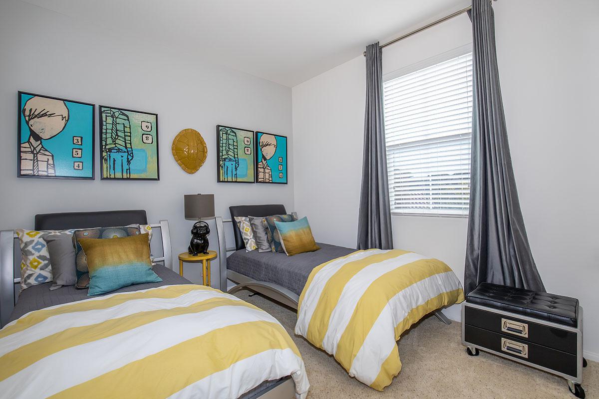 a bedroom with a bed and desk in a room
