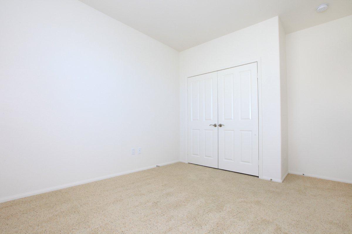 a bedroom with a wooden floor