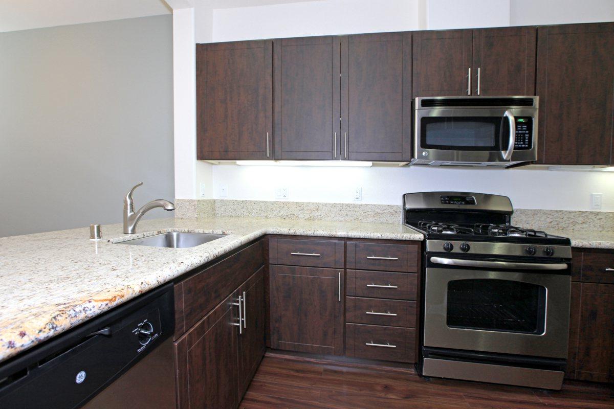 a kitchen with stainless steel appliances and wooden cabinets