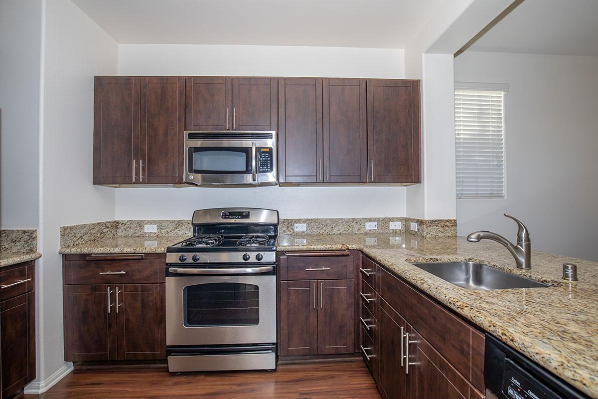 a kitchen with stainless steel appliances and wooden cabinets
