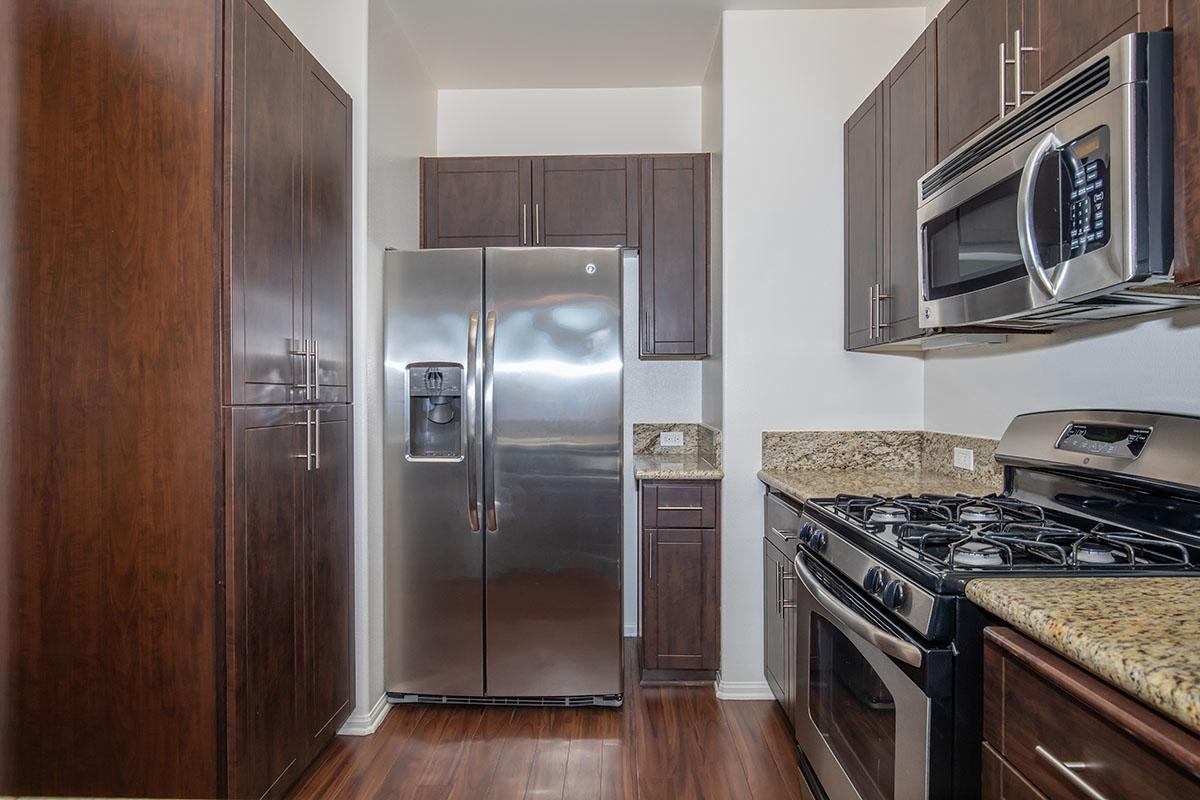 a kitchen with stainless steel appliances and wooden cabinets