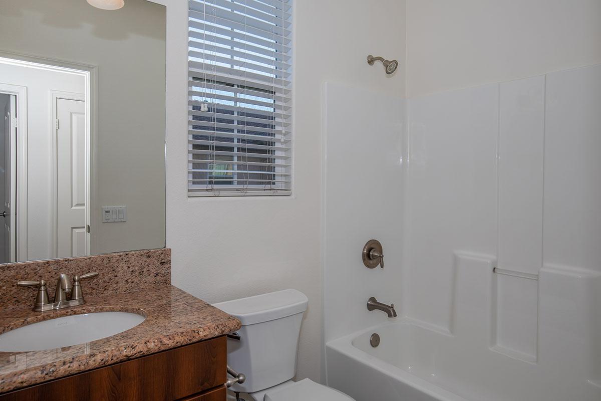 a room with a sink and a mirror