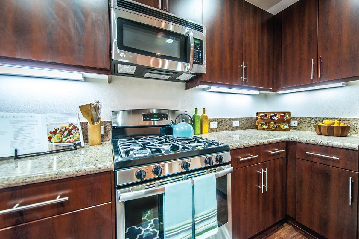 a kitchen with a stove a sink and a microwave