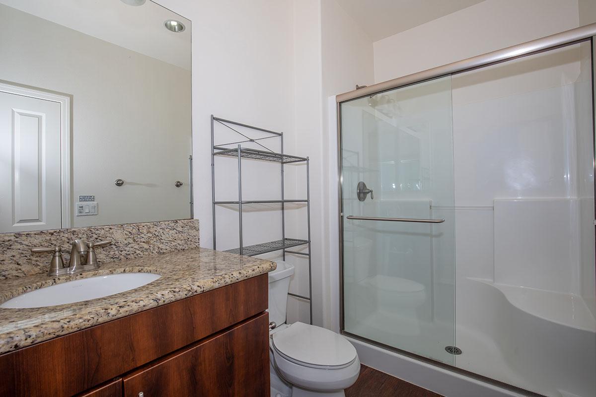 a large white tub next to a shower