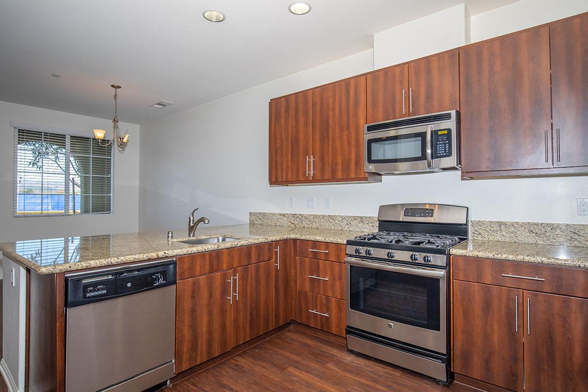 a kitchen with stainless steel appliances and wooden cabinets
