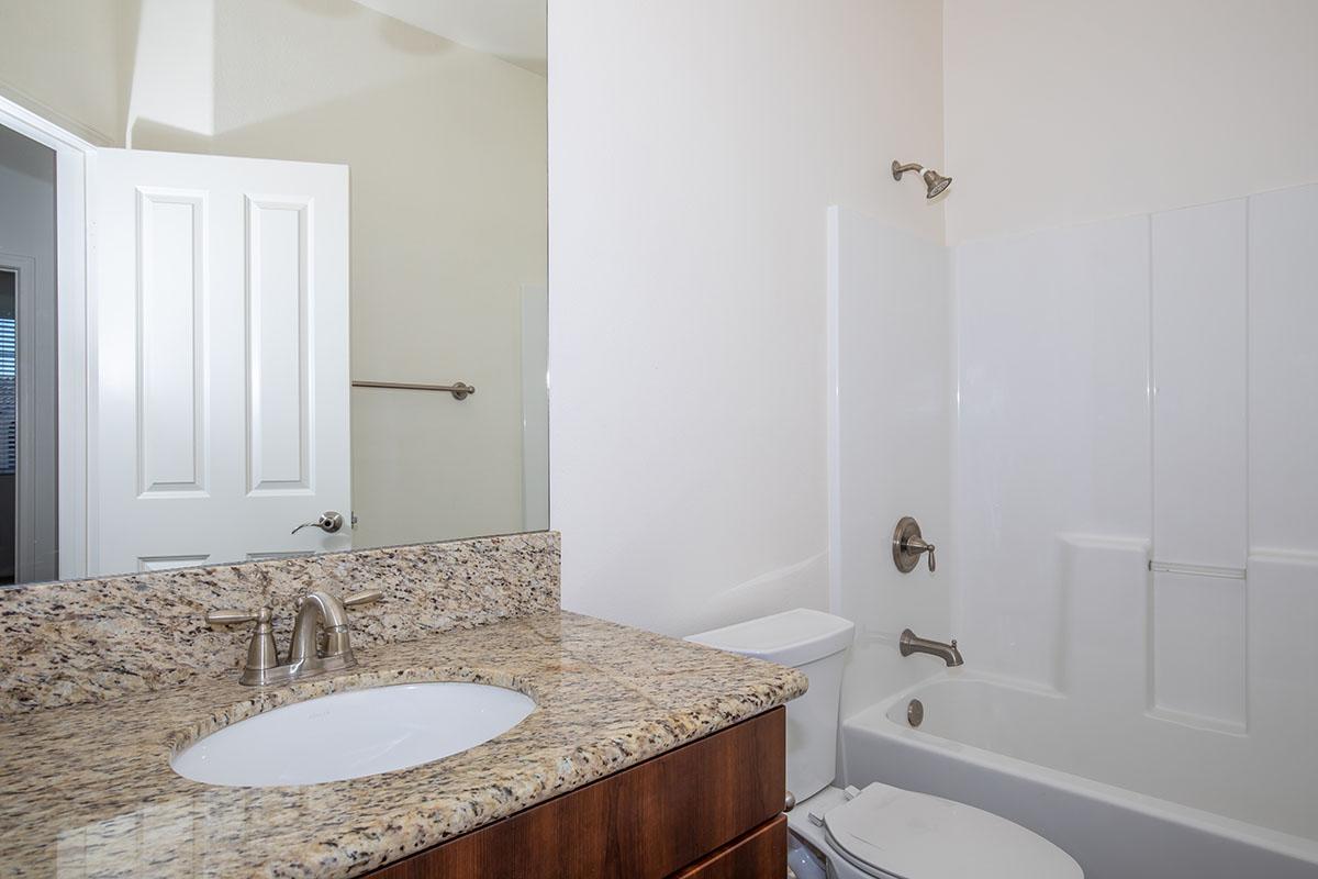 a large white tub next to a sink